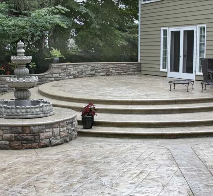 Stamped concrete patio with fountain in Puyallup, WA showing realistic stone texture and multi-tone coloring