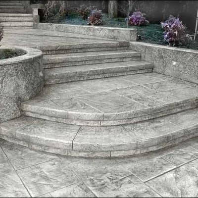 Stamped concrete walkway in Puyallup, WA showing realistic stone texture and saw cut design