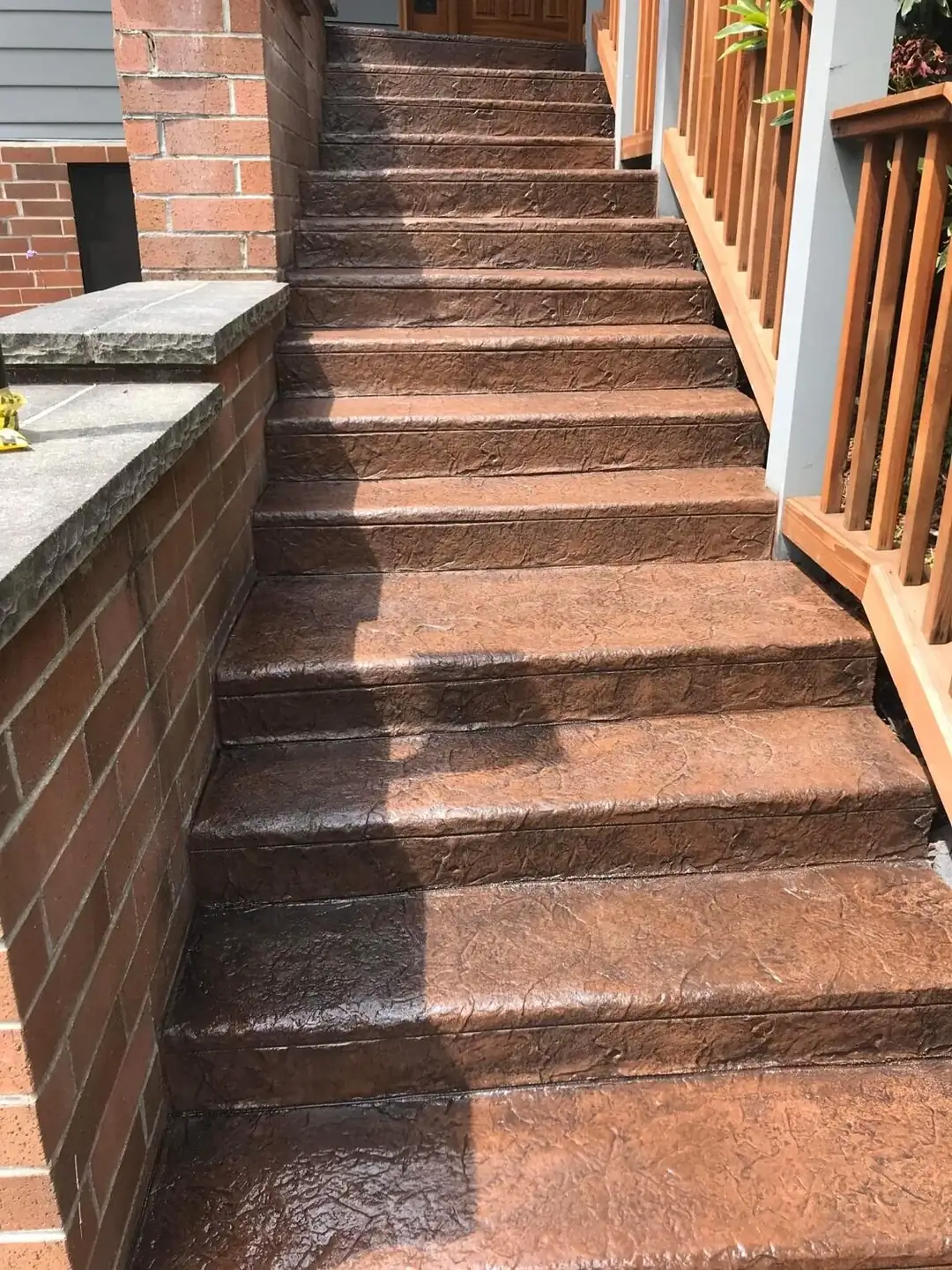 Full flight of stamped concrete steps in Tacoma with a consistent brown, textured stone finish.